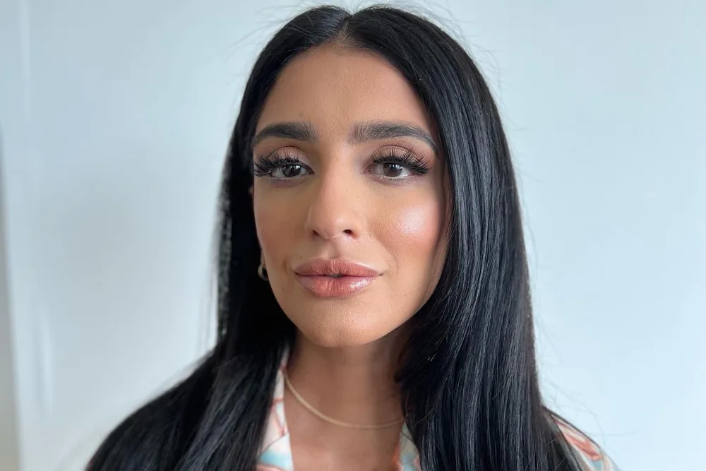 Client with polished, camera-ready makeup and sleek hair