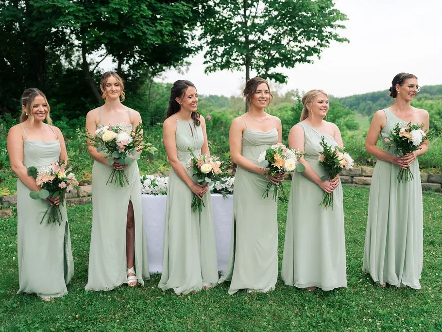 Bridesmaids in sage dresses with bouquets