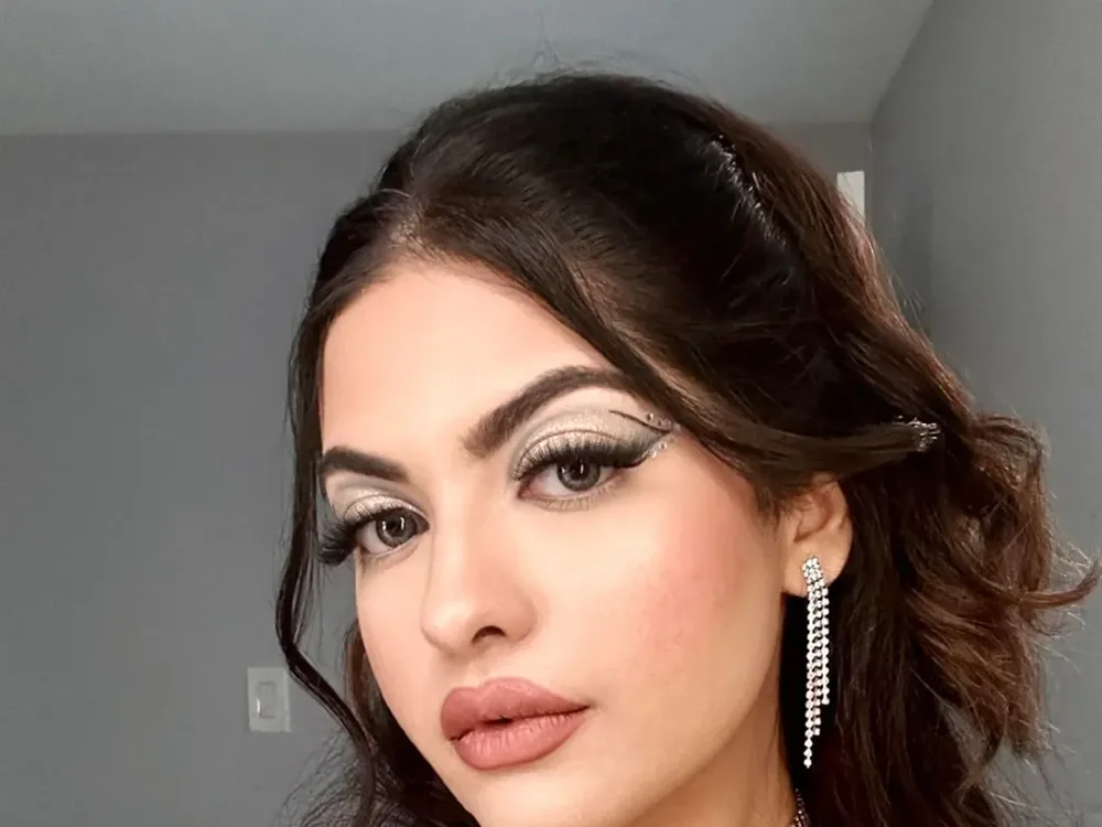 Wedding guest with glam makeup and soft curls